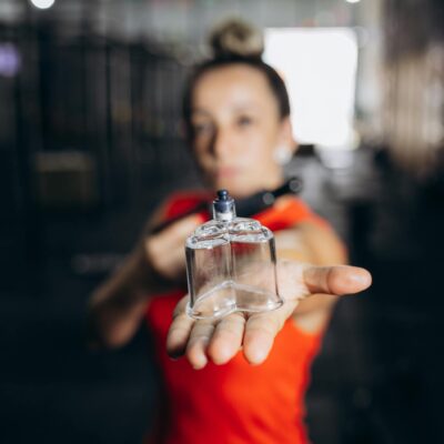 A woman holding a perfume bottle in her hand