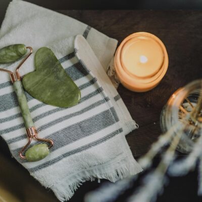 White and Green Textile Beside Orange Plastic Lid