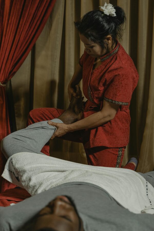 Woman in Red Dress Sitting on Bed